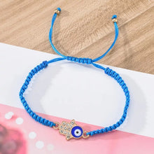 Load image into Gallery viewer, 12 pcs Rope HAMSA hand evil eye bracelet mix color / 12 piezas de pulcera de hilo con mano de Fatima y ojo Turco