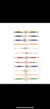 Load image into Gallery viewer, 12 pieces of multicolor evil eye bracelets.